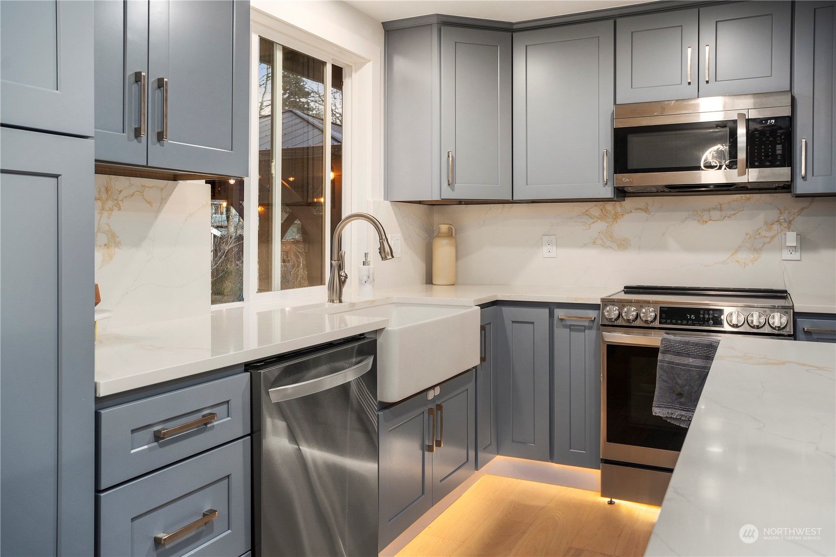 24301 7th Place West Bothell, WA 98021 - Photo 8 of 38 a kitchen with stainless steel appliances a stove microwave and sink