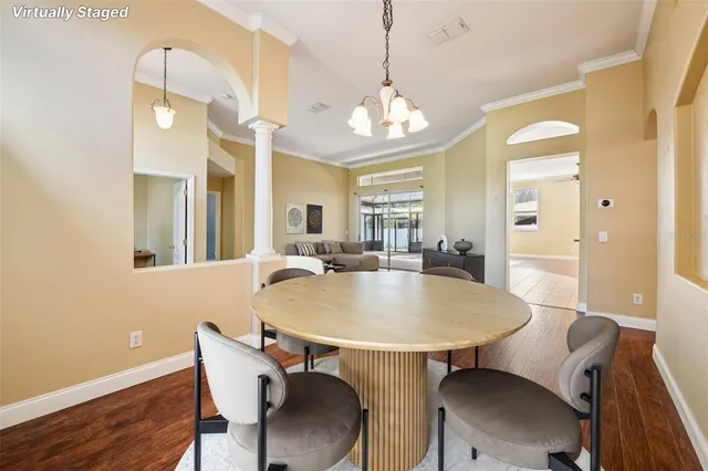 a view of a dining room with furniture and wooden floor