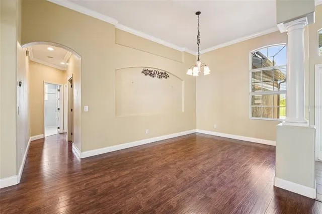 a view of a room with wooden floor and windows