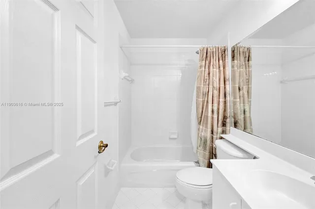 a bathroom with a toilet and a bathtub