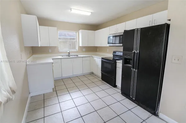 a kitchen with appliances cabinets and a sink