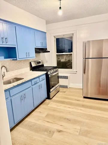 a kitchen with stainless steel appliances granite countertop a stove a sink dishwasher a refrigerator and a microwave