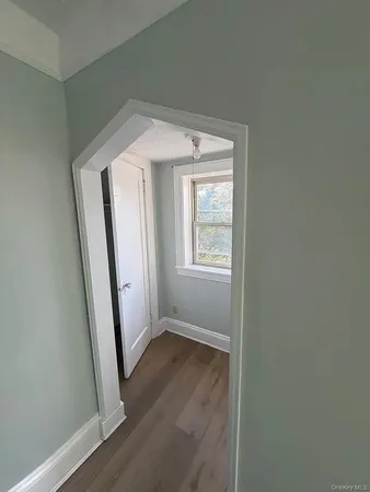 an entryway view with wooden floor and staircase