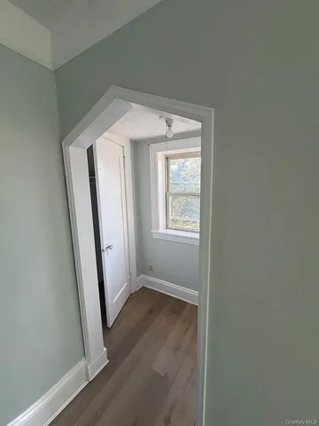 an entryway view with wooden floor and staircase