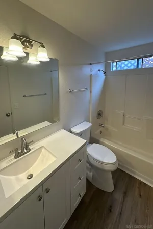 a bathroom with a sink toilet a mirror and shower