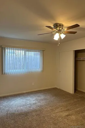 a view of room with a ceiling fan and window