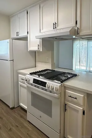 a view of kitchen with granite countertop cabinets sink and dishwasher