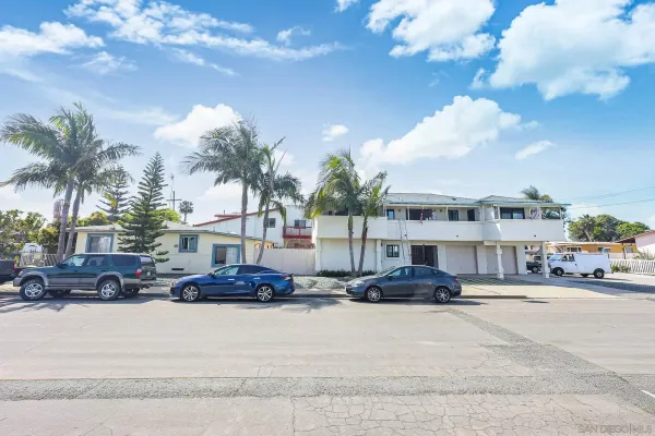 an aerial view of a house with yard and patio