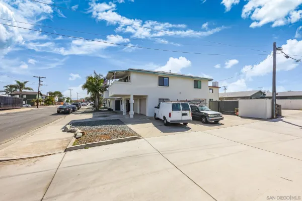 a view of a street with cars parked
