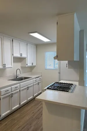 a kitchen with stainless steel appliances granite countertop a sink stove and cabinets