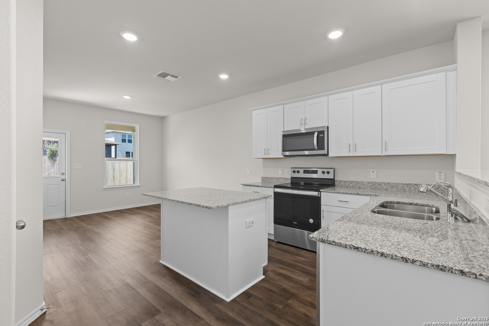 4137 Bermuda Lane Seguin, TX 78155 - Photo 14 of 24 a kitchen with granite countertop stainless steel appliances and wooden cabinets