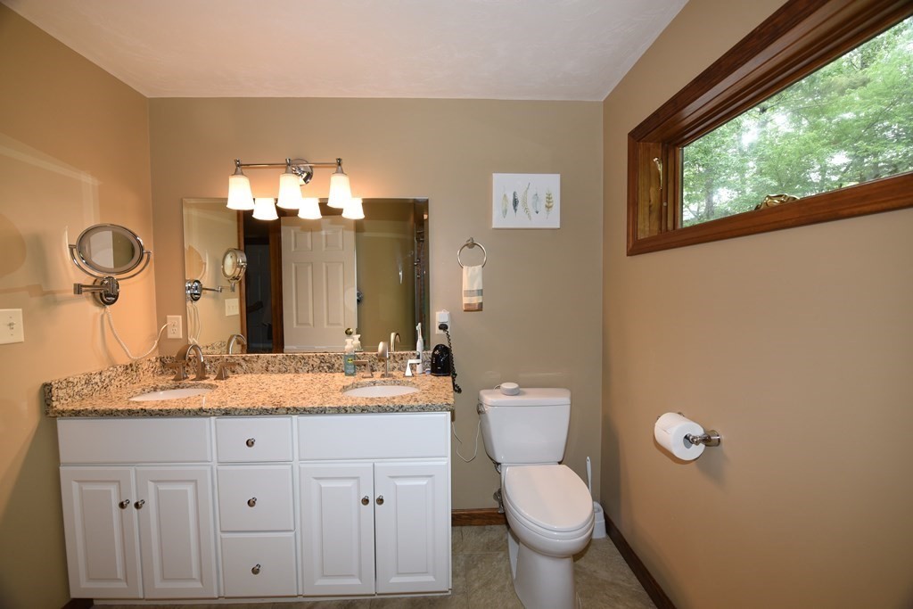 204 Marion Road Middleboro, MA 02346 - Photo 28 of 40 a bathroom with a granite countertop toilet sink and mirror