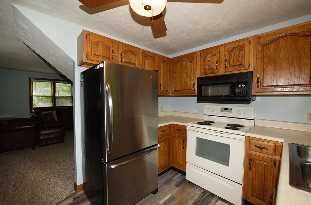 204 Marion Road Middleboro, MA 02346 - Photo 31 of 40 a kitchen with stainless steel appliances a refrigerator stove and microwave