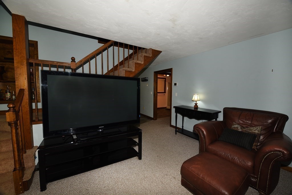 204 Marion Road Middleboro, MA 02346 - Photo 34 of 40 a living room with furniture and a flat screen tv