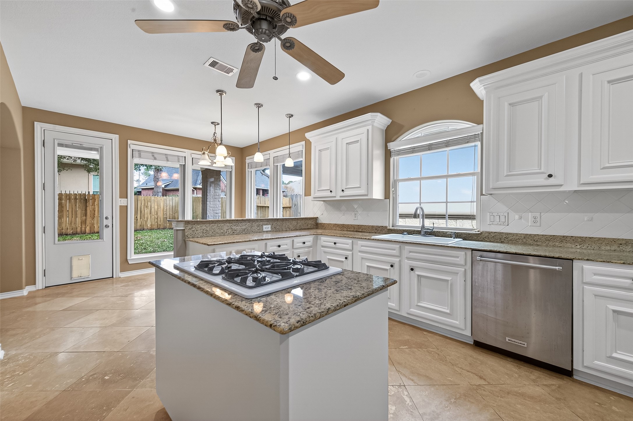 15 Wick Willow Road Montgomery, TX 77356 - Photo 19 of 49 a kitchen with stainless steel appliances granite countertop a stove a sink dishwasher a dining table and chairs with wooden floor