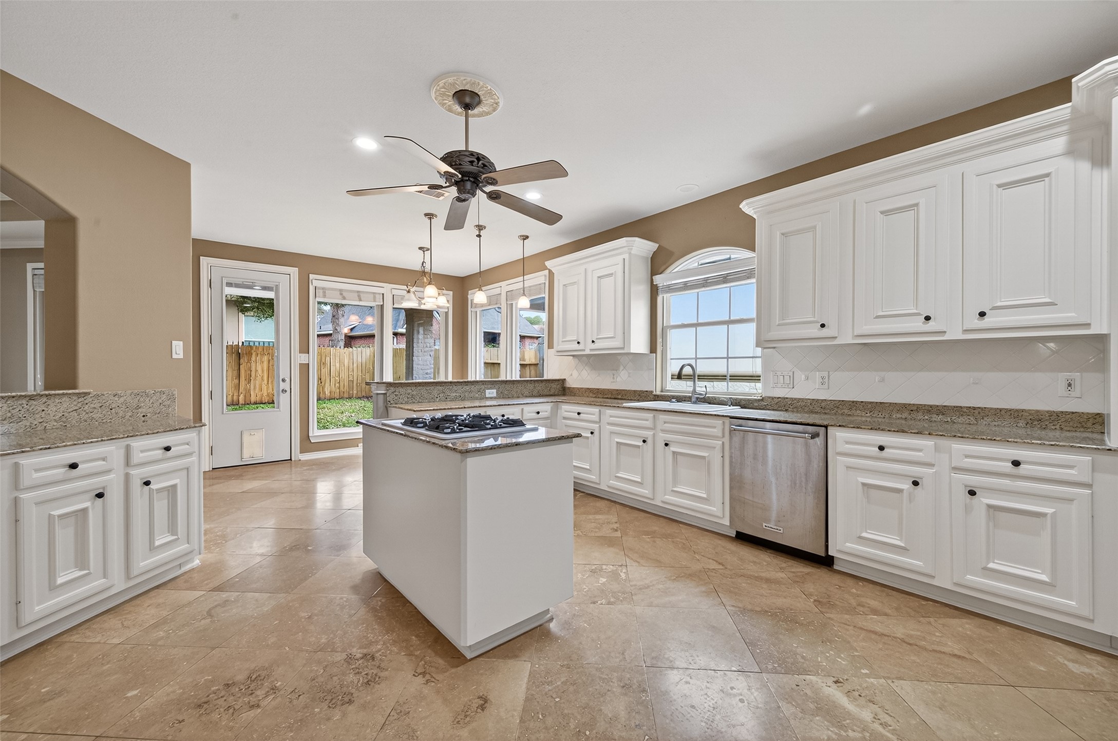 15 Wick Willow Road Montgomery, TX 77356 - Photo 20 of 49 a kitchen with granite countertop a sink stove and white cabinets