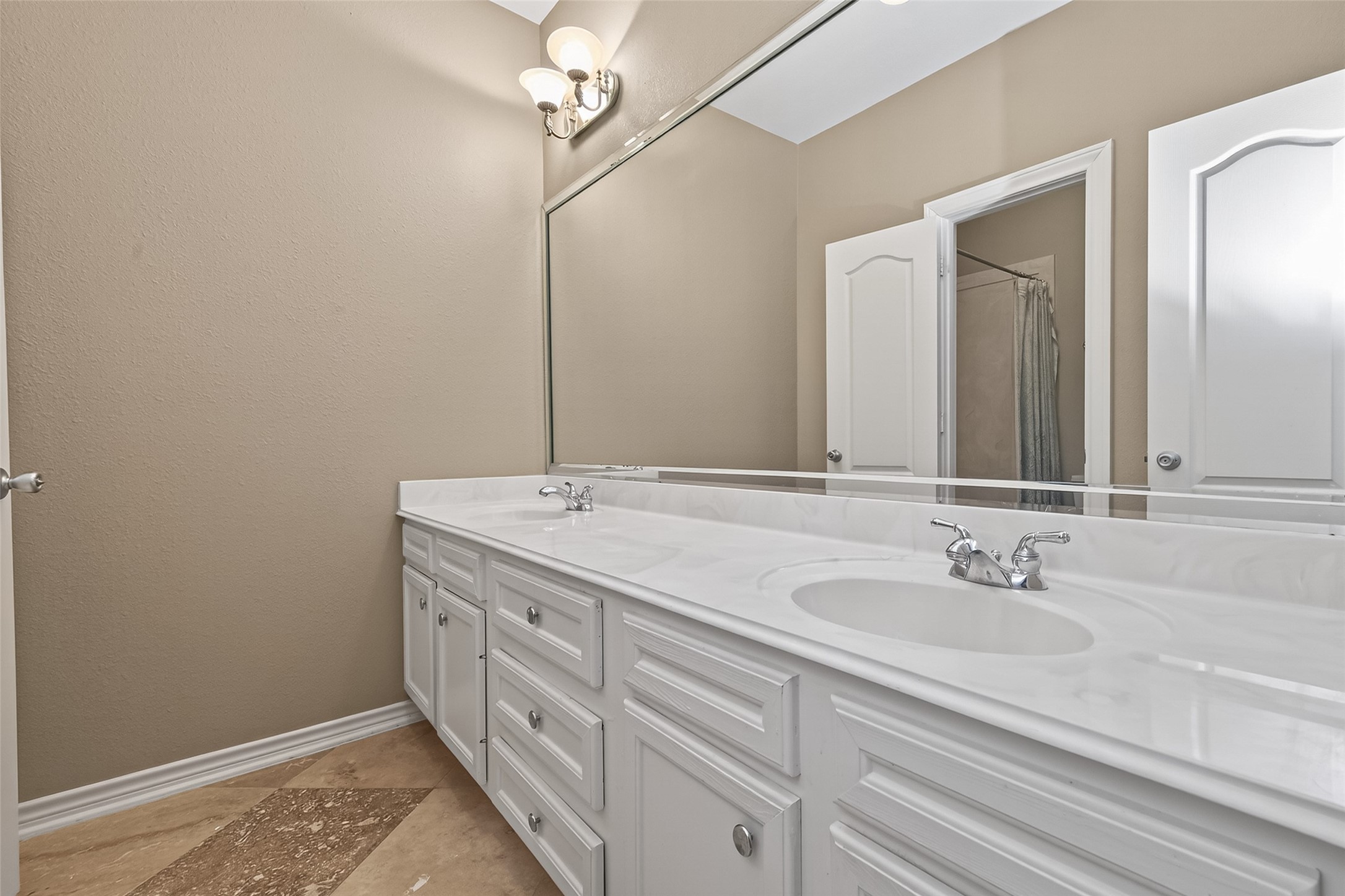 15 Wick Willow Road Montgomery, TX 77356 - Photo 37 of 49 a bathroom with a double vanity sink and a mirror
