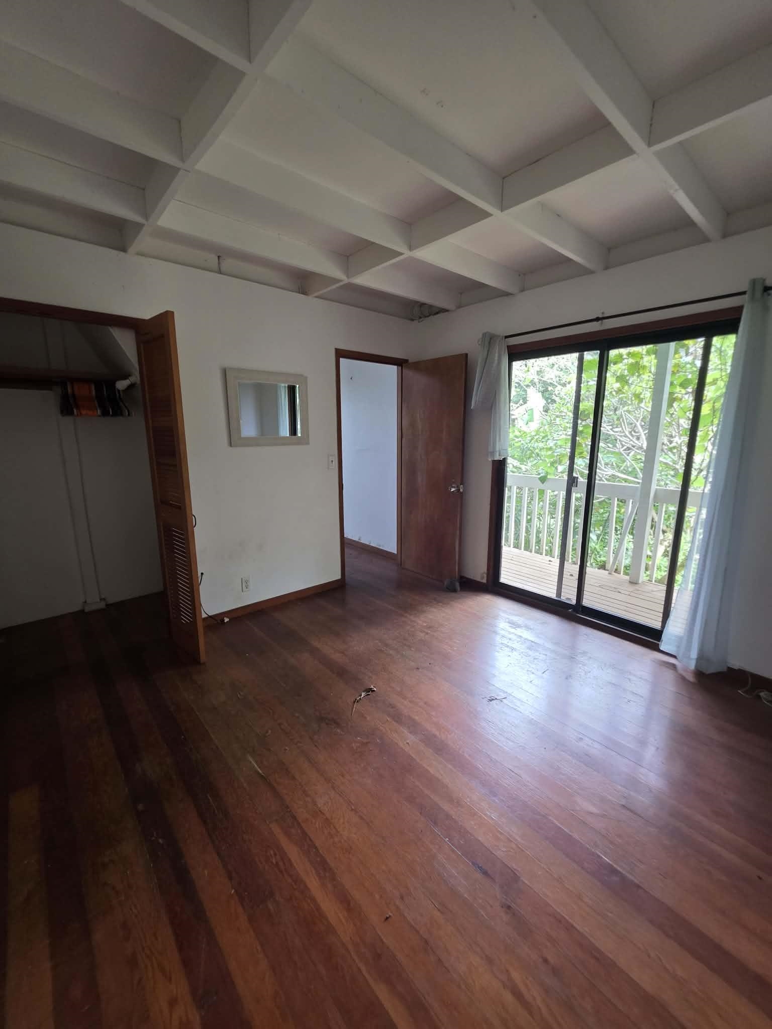 420 Haumana Road Haiku, HI 96708 - Photo 24 of 31 wooden floor in an empty room with a window