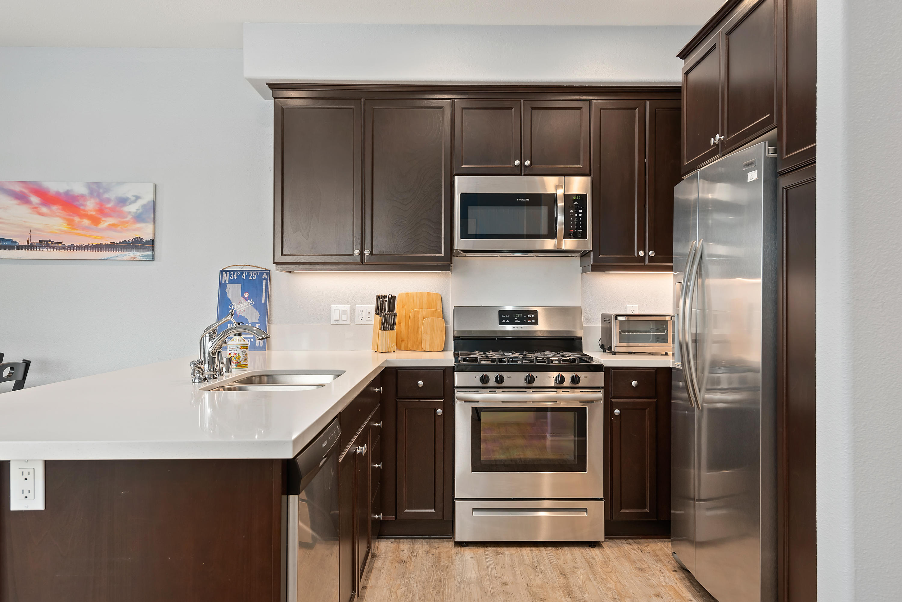 242 Robles Way Buellton, CA 93427 - Photo 4 of 25 a kitchen with a sink stove and microwave