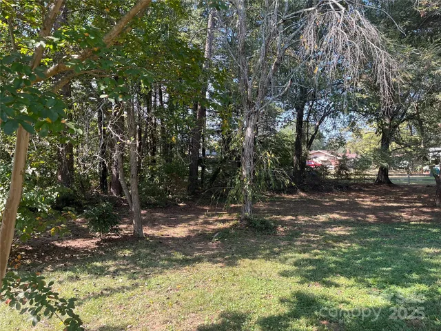 a backyard of a house with lots of trees