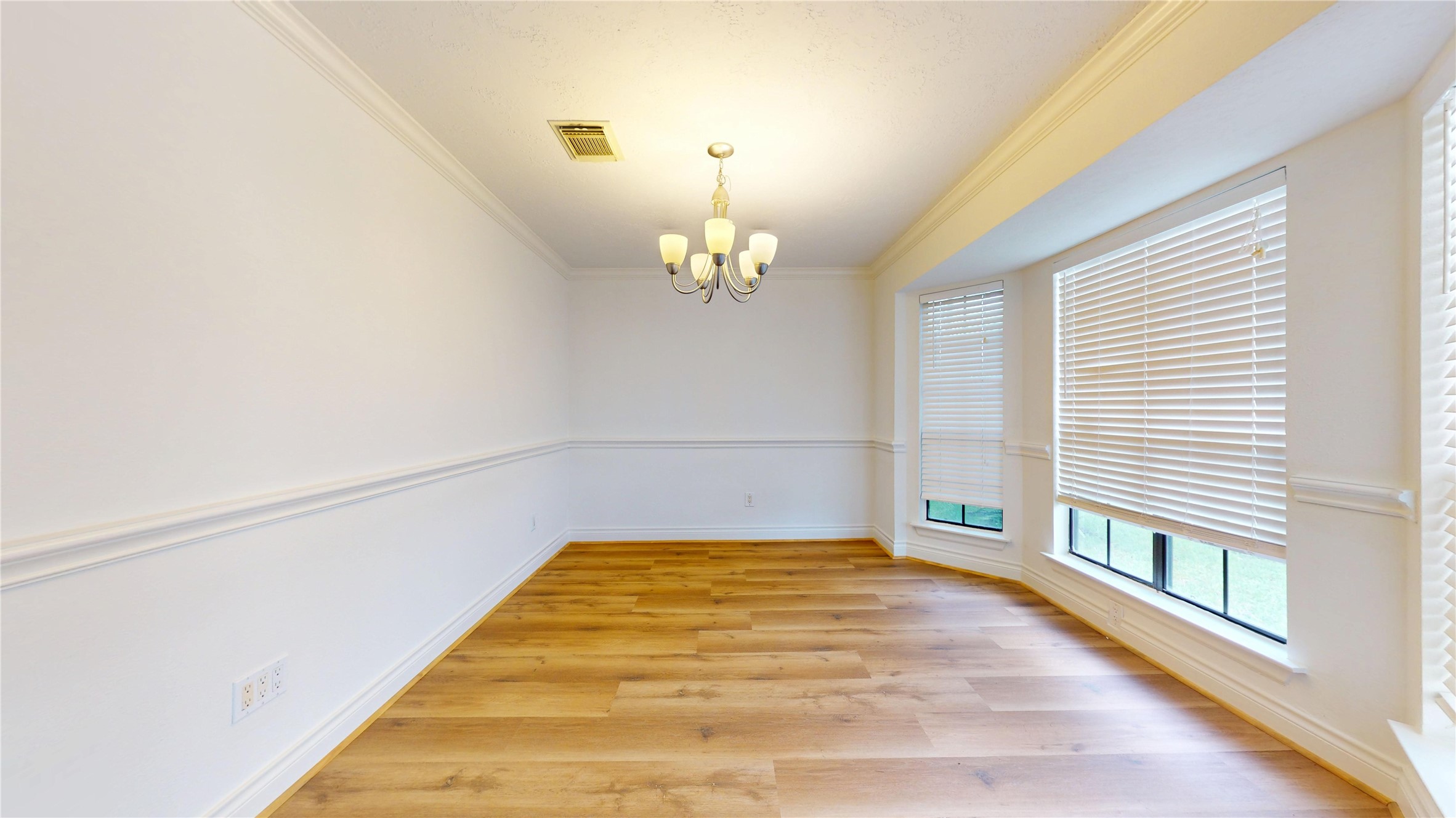 The inviting dining room offers an elegant setting for both intimate dinners and larger gatherings. Abundant natural light creates a bright, welcoming atmosphere, while the spacious layout provides plenty of room for a dining table and furnishings.
