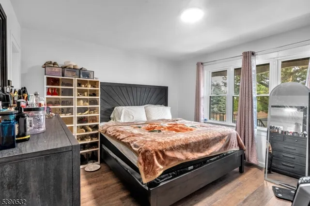 a bed sitting in a bedroom next to a window