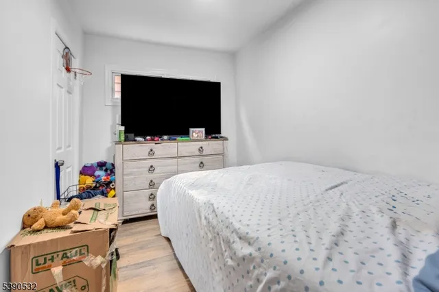 a bedroom with a bed and flat screen tv
