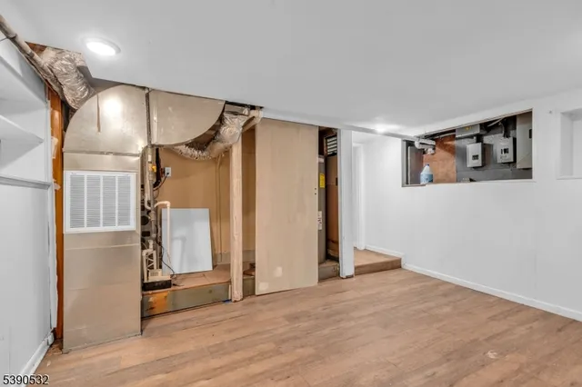 a view of hallway with wooden floor and stairs