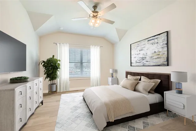 a bedroom with a large bed and a flat screen tv