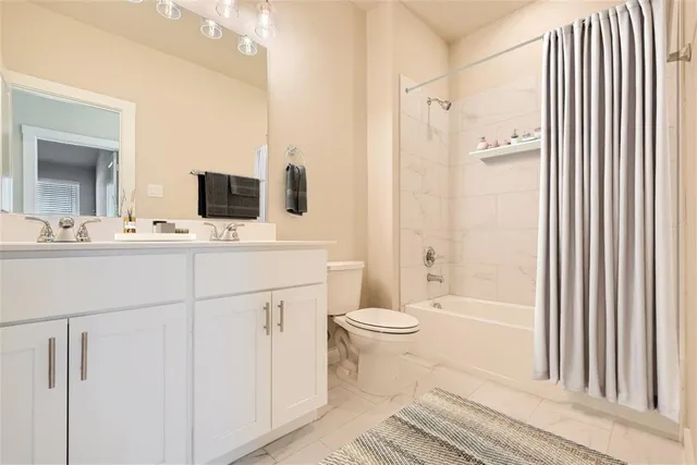 a bathroom with a toilet a sink and a bathtub