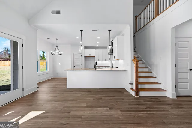 a view of kitchen with cabinets and wooden floor