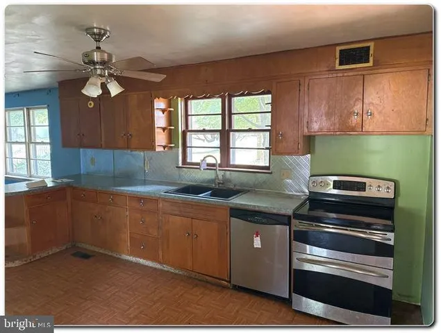 a kitchen with granite countertop stainless steel appliances and wooden cabinets