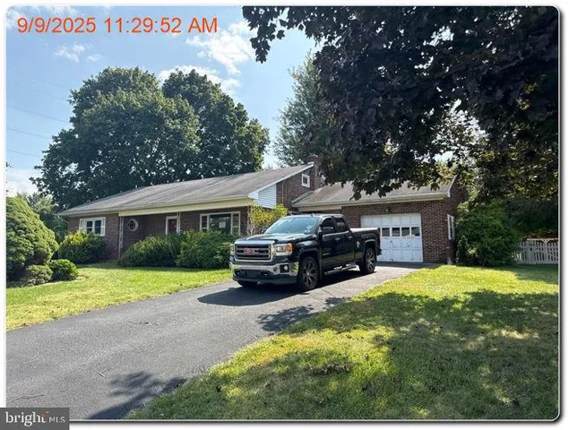a view of a house with a yard porch and sitting area