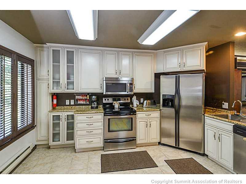 1944 Soda Ridge Road, Unit 1229 Keystone, CO 80435 - Photo 2 of 17 a kitchen with a refrigerator and a stove