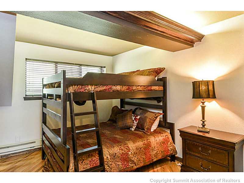 1944 Soda Ridge Road, Unit 1229 Keystone, CO 80435 - Photo 14 of 17 a bedroom with a bed and a night stand