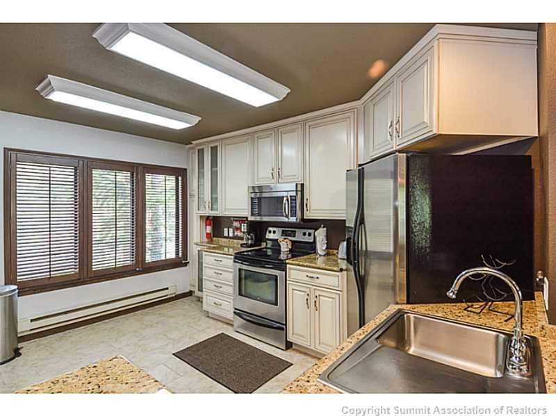 1944 Soda Ridge Road, Unit 1229 Keystone, CO 80435 - Photo 3 of 17 a kitchen with stainless steel appliances granite countertop a stove a sink dishwasher a refrigerator and cabinets with wooden floor