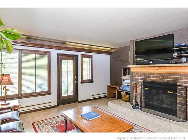 1944 Soda Ridge Road, Unit 1229 Keystone, CO 80435 - Photo 7 of 17 a living room with furniture a flat screen tv and a fireplace