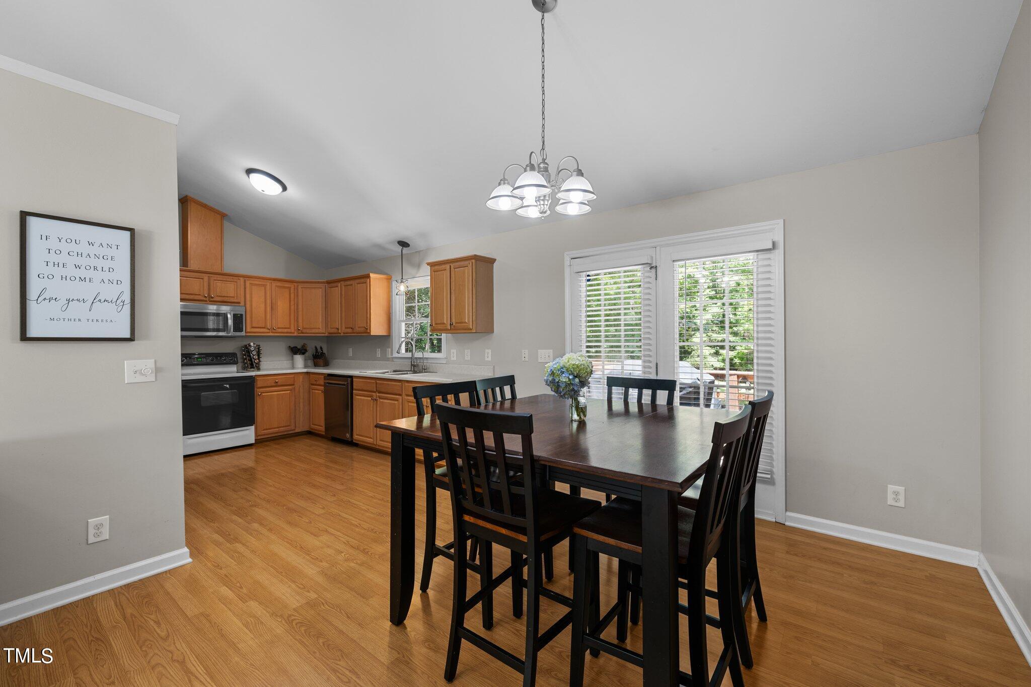 7031 Calais Drive Durham, NC 27712 - Photo 11 of 48 a view of a dining room with furniture window and wooden floor