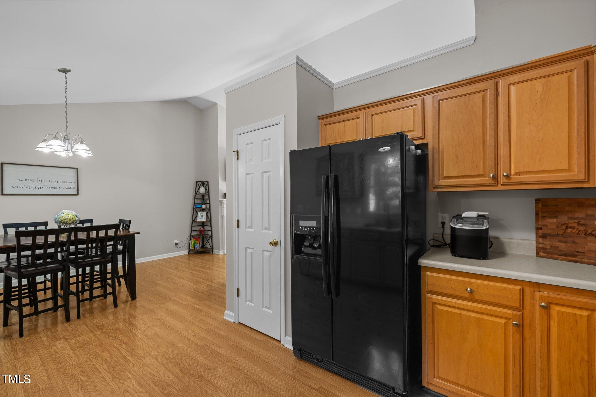 7031 Calais Drive Durham, NC 27712 - Photo 16 of 48 a kitchen with stainless steel appliances granite countertop a refrigerator a stove and a wooden cabinets