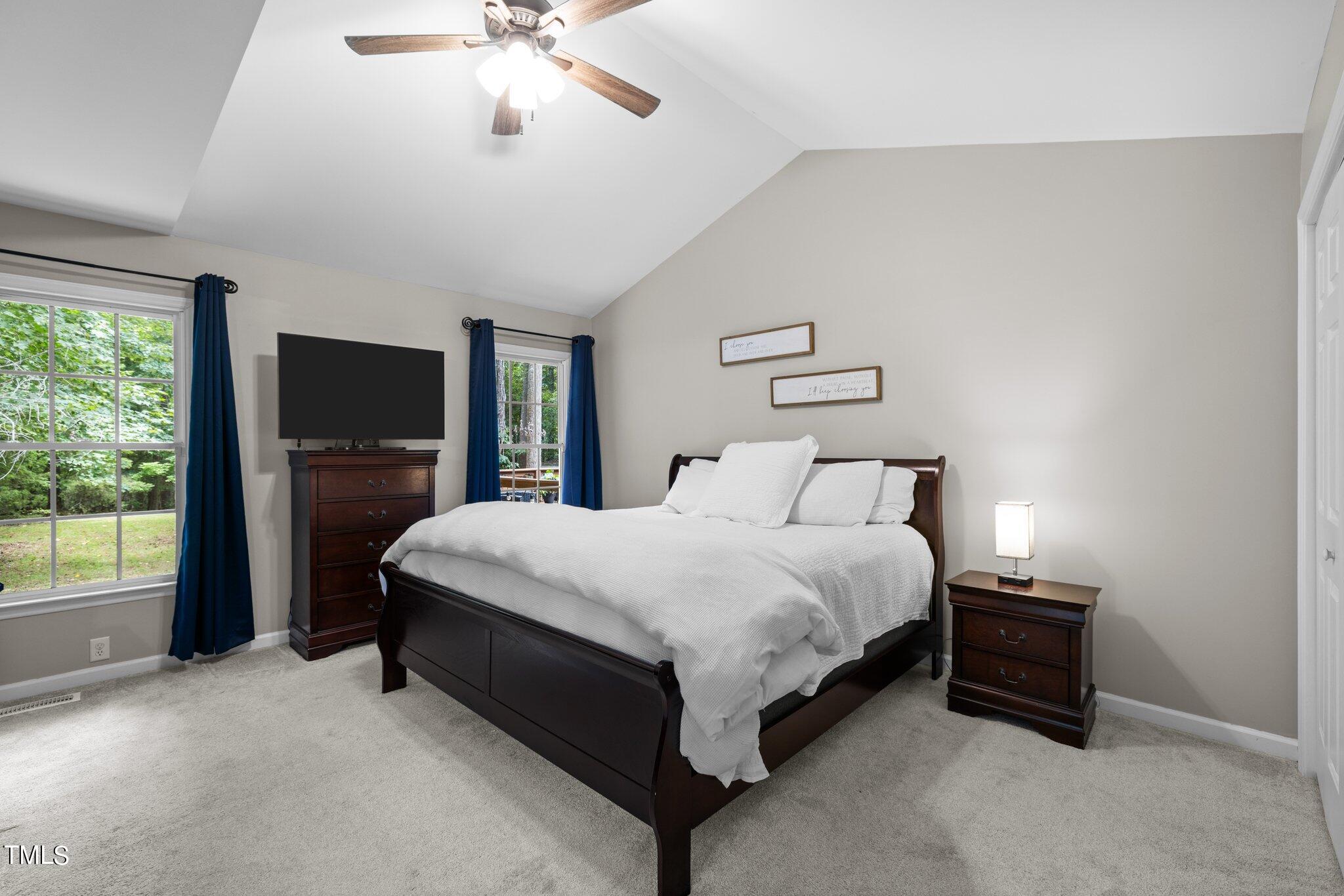 7031 Calais Drive Durham, NC 27712 - Photo 18 of 48 a spacious bedroom with a bed and a chandelier