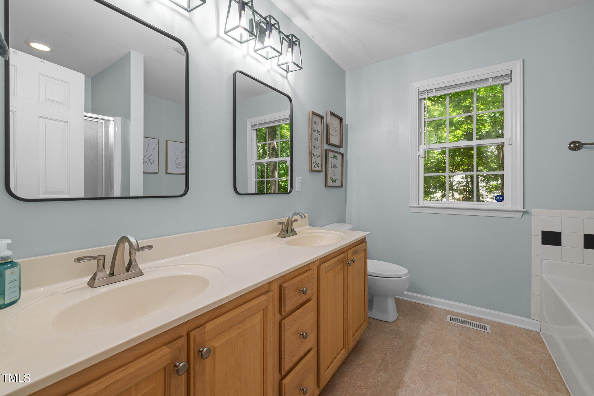 7031 Calais Drive Durham, NC 27712 - Photo 20 of 48 a bathroom with a sink and a mirror