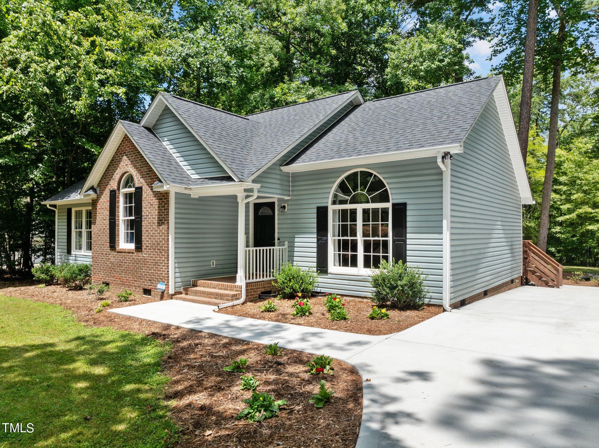 7031 Calais Drive Durham, NC 27712 - Photo 2 of 48 a front view of a house with a yard outdoor seating and yard