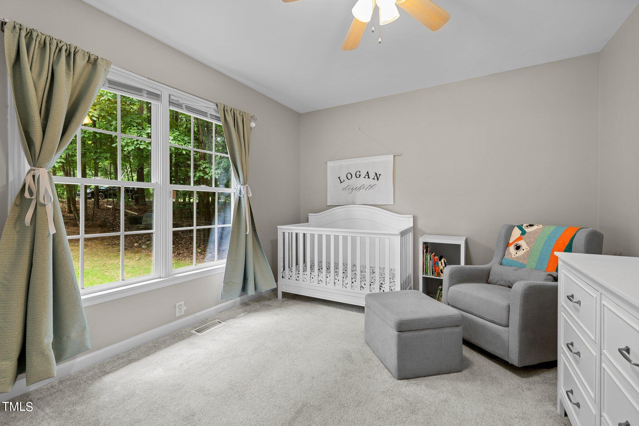 7031 Calais Drive Durham, NC 27712 - Photo 22 of 48 a bedroom with furniture and a large window