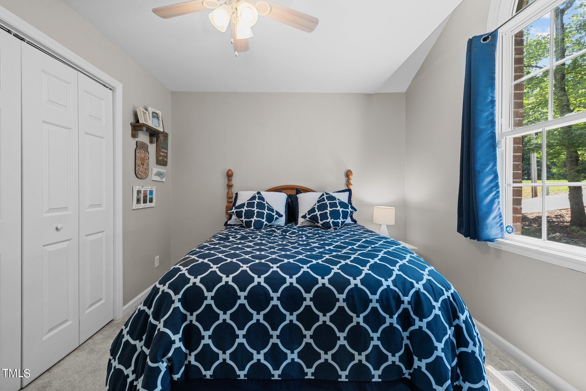 7031 Calais Drive Durham, NC 27712 - Photo 24 of 48 a bedroom with a bed and a window