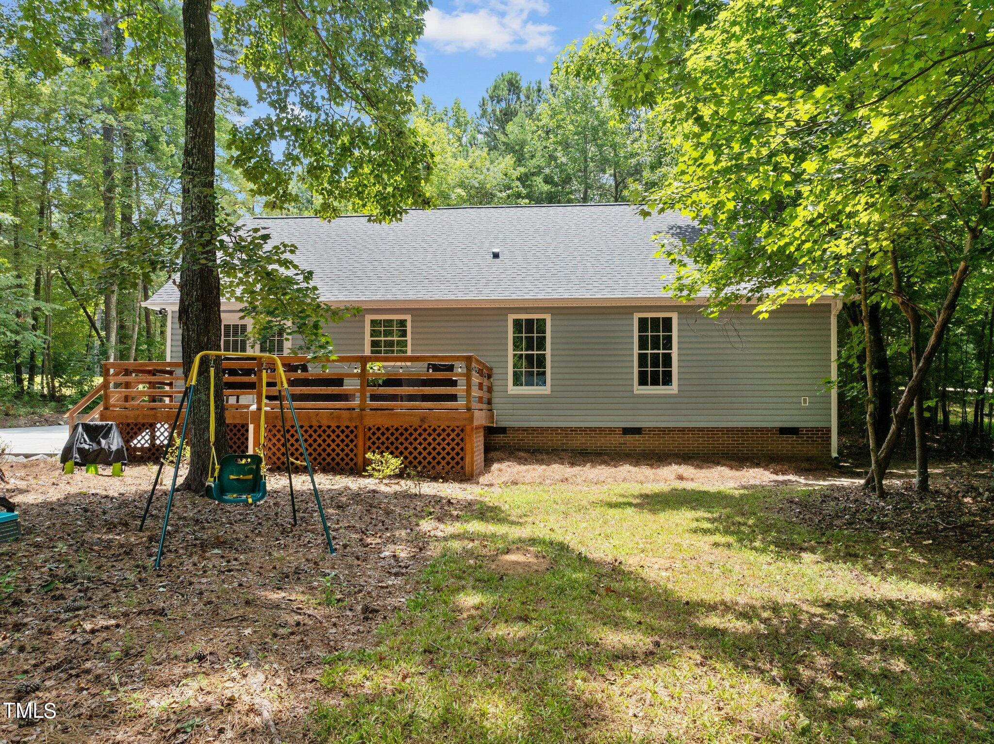 7031 Calais Drive Durham, NC 27712 - Photo 33 of 48 a view of a backyard with table and chairs and a barbeque