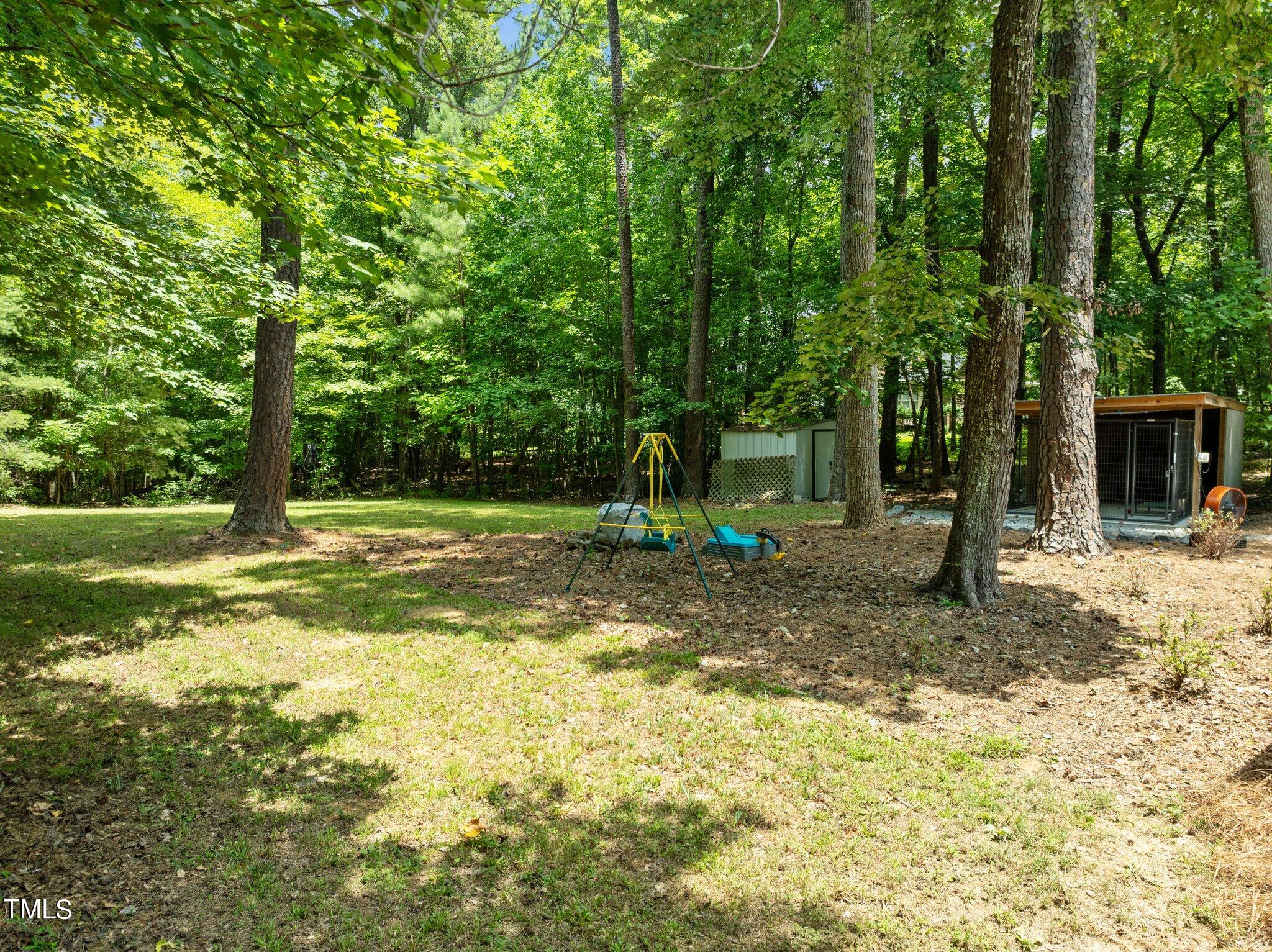 7031 Calais Drive Durham, NC 27712 - Photo 37 of 48 a view of a yard with a tree