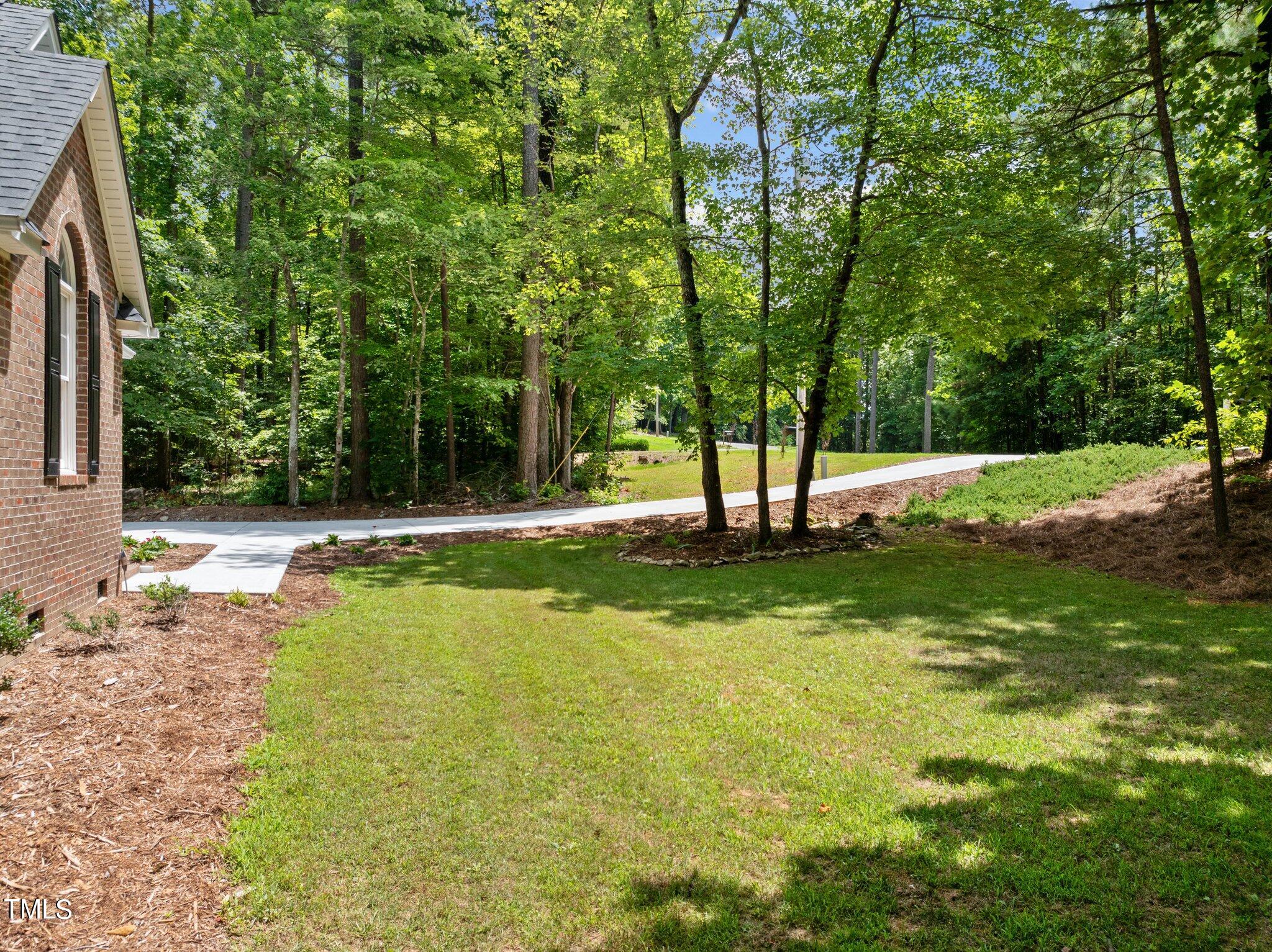 7031 Calais Drive Durham, NC 27712 - Photo 40 of 48 a view of a backyard with swimming pool