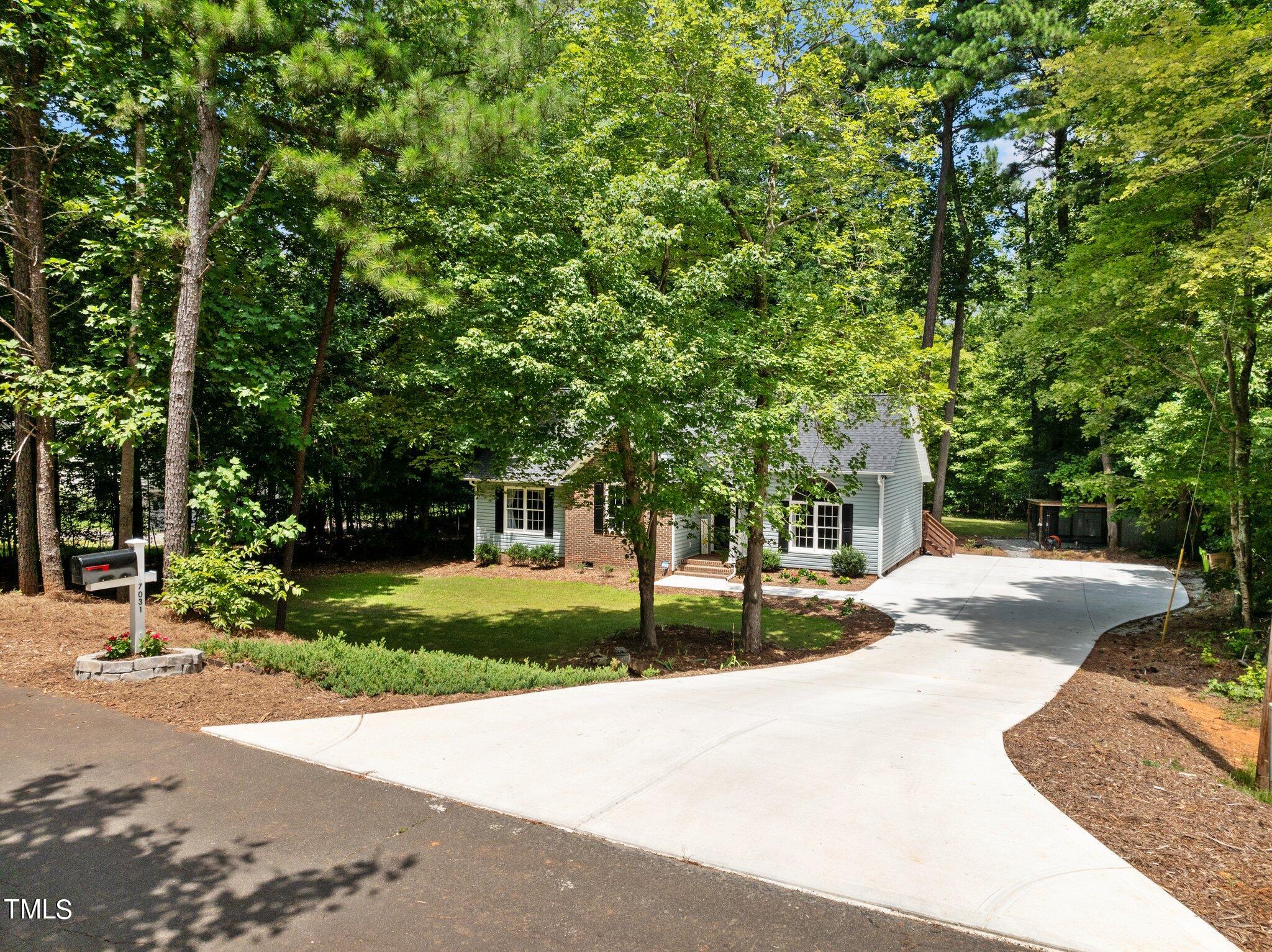 7031 Calais Drive Durham, NC 27712 - Photo 41 of 48 a view of a house with a tree in front of it