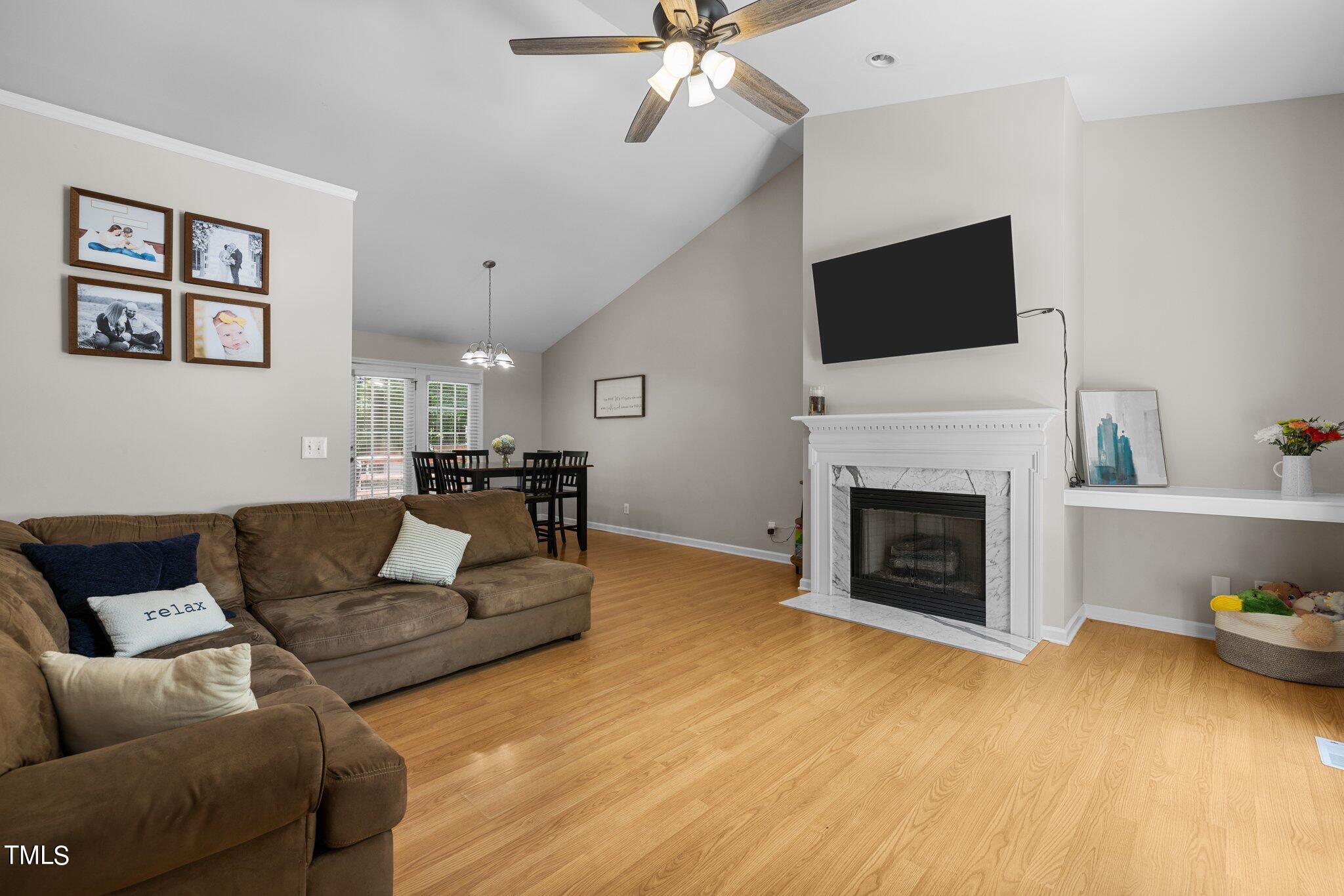7031 Calais Drive Durham, NC 27712 - Photo 5 of 48 a living room with furniture fireplace and flat screen tv