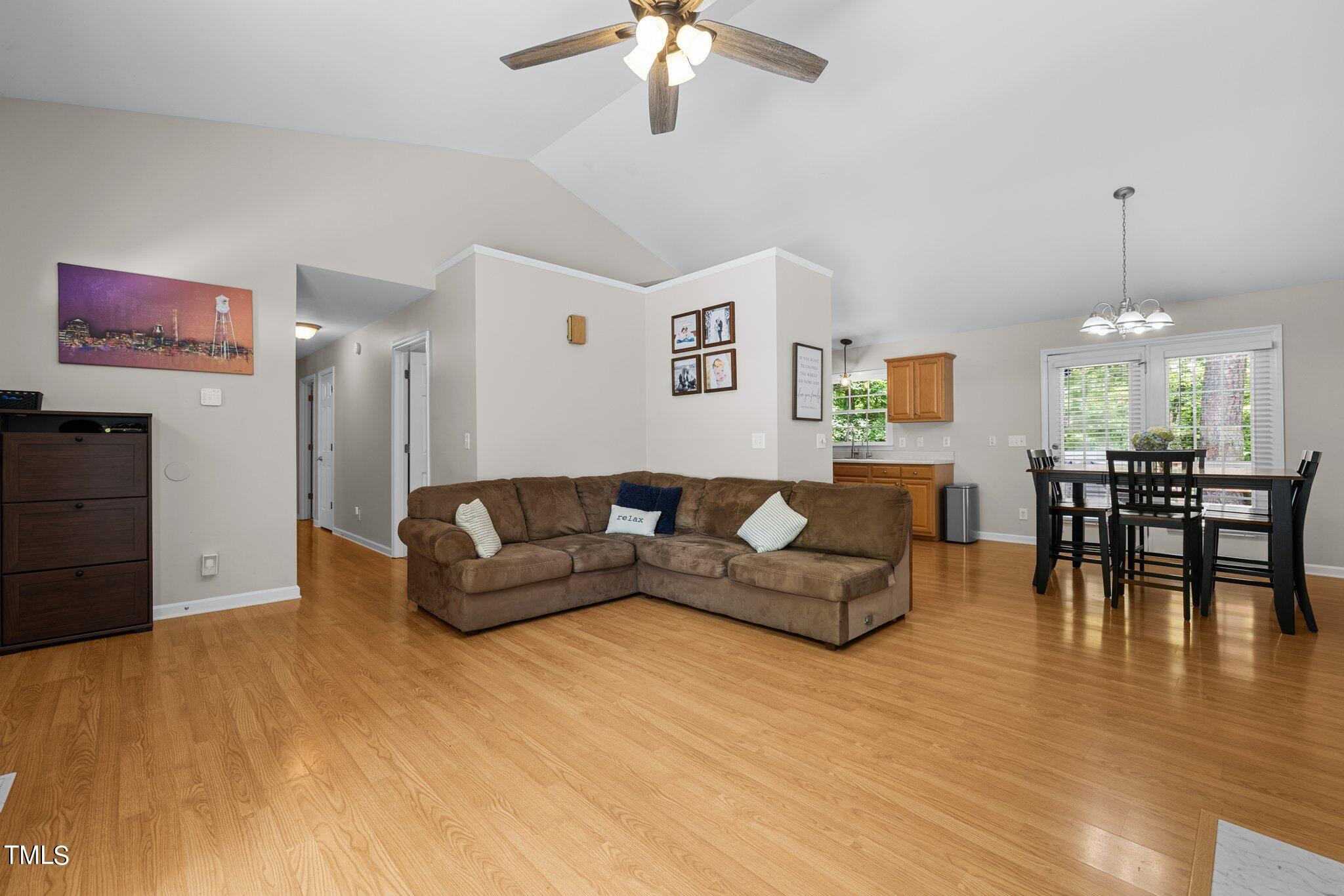 7031 Calais Drive Durham, NC 27712 - Photo 8 of 48 a living room with furniture and a chandelier